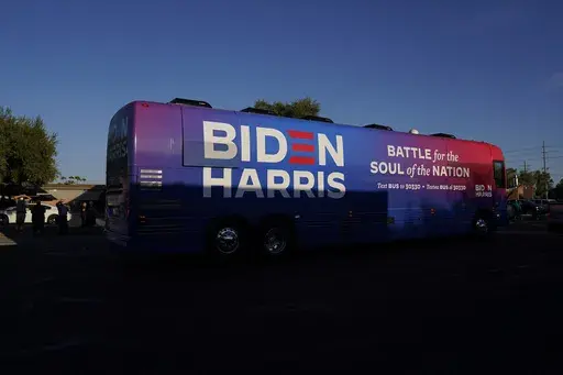 Democratic presidential candidate former Vice President Joe Biden and Democratic vice presidential candidate Sen. Kamala Harris, D-Calif., ride on a bus in Phoenix, Oct. 8, 2020, on a small business bus tour. (AP Photo/Carolyn Kaster, File)