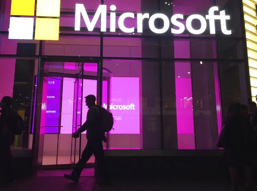 People walk past a Microsoft office in New York on Nov. 10, 2016. (AP Photo/Swayne B. Hall, File)