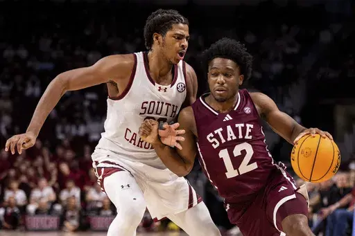 Mississippi State guard Josh Hubbard (12) drives on South Carolina forward Collin Murray-Boyles, left, during the first half of an NCAA college basketball game on Saturday, Jan. 25, 2025, in Columbia, S.C. (AP Photo/Scott Kinser)