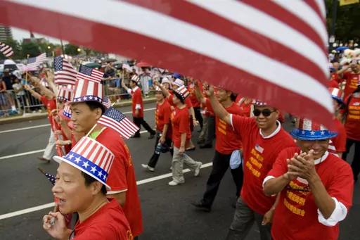 Tang De Wong, lower left, and other members of the Chinese Benevolent Association march in an Independence Day parade in Philadelphia, July 4, 2008. Flags proliferate every July Fourth, but it wasn't always a revered and debated symbol. Unlike the right to assemble or trial by jury, the flag's role was not prescribed by the founders: Flags would have been rare during early Independence Day celebrations and were so peripheral to early U.S. history that no original flag exists. (AP Photo/Matt Rour