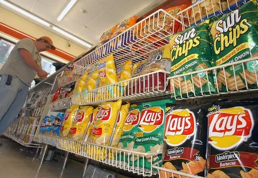 A customer makes a purchase at a convenience store in Boston in this July 12, 2005 file photo. (AP Photo/Lisa Poole, file)