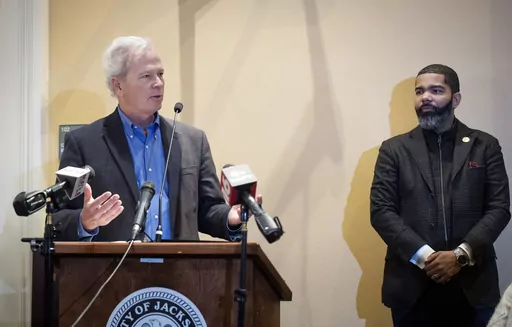 Ted Henifin, left, the City of Jackson water system third-party administrator, addresses media questions during a news conference at City Hall as Jackson Mayor Chokwe Antar Lumumba listens on Dec. 5, 2022, in Jackson, Miss. A District Court Judge said Tuesday, May 9, 2023, that he plans on placing Jackson's sewer system under the authority of Henifin, who was appointed in November to address the city's water troubles. The water system partially failed in August, and for days people had to wait i