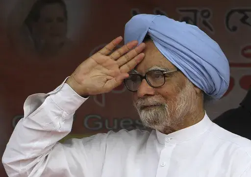 Indian Prime Minister Manmohan Singh greets the crowd during an election campaign rally at Khumtai, in the northeastern Indian state of Assam, Saturday, March 29, 2014. (AP Photo/Anupam Nath, File)