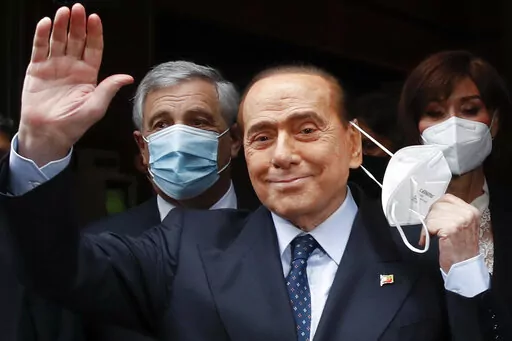 Former Italian Premier Silvio Berlusconi waves to reporters as he arrives at the Chamber of Deputies to meet Mario Draghi, in Rome, on Feb. 9, 2021. Former premier Silvio Berlusconi has bowed out of Italy’s presidential election set for next week. Berlusconi, 85, said in a statement on Saturday that he had decided to “take another step on the path of national responsibility.” The media mogul  insisted he had nailed down enough voters to become head of state, but he asked his supporters no