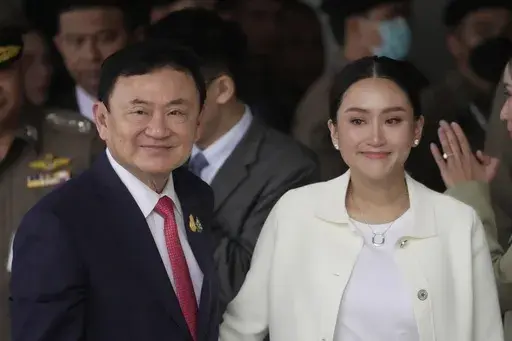Thailand's former Prime Minister Thaksin Shinawatra, left, with, his daughter Paetongtarn, arrives at Don Muang airport in Bangkok, Thailand, Tuesday, Aug. 22, 2023.(AP Photo/Sakchai Lalit, File)