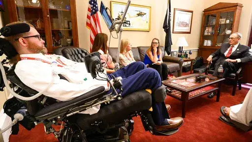In this photo provided by The ALS Association, representatives from the group meet with former Tennessee Congressman Phil Roe, right, in his offices on Capitol Hill in Washington on March 14, 2022. The ALS Association and other patient groups have been lobbying federal officials for over a year seeking access to an experimental drug from Amylyx Pharmaceuticals. The Food and Drug Administration will soon meet to review the drug’s safety and effectiveness. (Kevin Allen/The ALS Association via AP