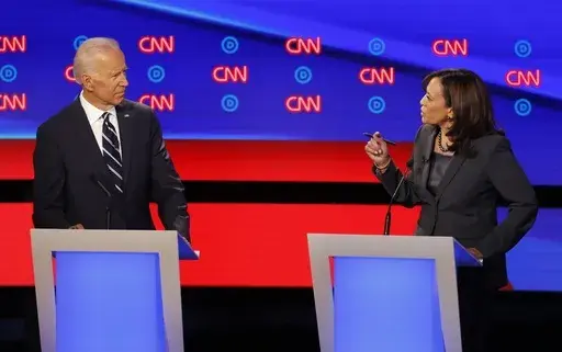 Former Vice President Joe Biden, left, listens as Sen. Kamala Harris, D-Calif., speaks during a Democratic presidential primary debates, July 31, 2019, in Detroit. (AP Photo/Paul Sancya, File)