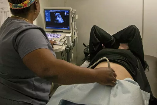 An operating room technician performs an ultrasound on a patient at an abortion clinic in Shreveport, La., Wednesday, July 6, 2022. Serious pregnancy complications are rare in the United States but they still affect thousands of women each year. (AP Photo/Ted Jackson, File)
