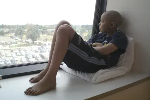 This photo provided by Jeng Hsu shows her son, Jaiwen Hsu, at the Children's National Hospital in Washington in August 2011, weeks before his last round of chemotherapy for bone cancer. (Jeng Hsu via AP)