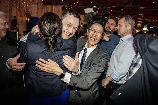 Chairman of Demokraatit, Jens-Frederik Nielsen, center, hugs supporters during the election party at Demokraatit by cafe Killut in Nuuk, early Wednesday, March 12, 2025. (Mads Claus Rasmussen/Ritzau Scanpix via AP)