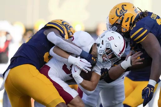 Stanford running back Mitch Leigber, middle, runs the ball against California during the first half of an NCAA college football game in Berkeley, Calif., Saturday, Nov. 19, 2022. Atlantic Coast Conference presidents and chancellors held a conference call Tuesday, Aug. 8, 2023, but took no action on West Coast expansion with California and Stanford, a person with knowledge of the situation told The Associated Press. (AP Photo/Godofredo A. Vásquez, File)