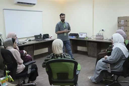 In this photo taken Tuesday, June 13, 2023, Jaser Alharasis, co-founder and CEO of a start-up that trains young Jordanians in robotics and artificial intelligence called Robotna, talks to his team in east Amman, Jordan. (AP Photo/Raad Adayleh)