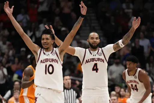 Auburn's Chad Baker-Mazara (10) and Johni Broome (4) react to play against Tennessee during the second half of an NCAA college basketball game in the semifinal round of the Southeastern Conference tournament, Saturday, March 15, 2025, in Nashville, Tenn. (AP Photo/George Walker IV)