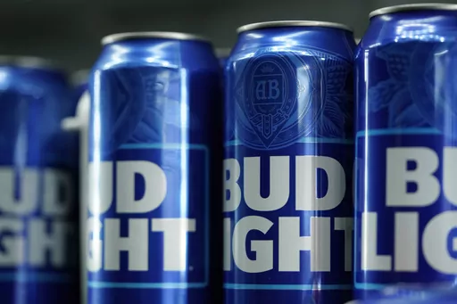 Cans of Bud Light beer are seen before a baseball game between the Philadelphia Phillies and the Seattle Mariners on April 25, 2023, in Philadelphia. The country's largest advocacy group for LGBTQ+ rights has suspended its benchmark equality and inclusion rating for Anheuser-Busch, citing the beer company's handling of hate-filled and transphobic backlash received after its partnership with transgender influencer Dylan Mulvaney in April. (AP Photo/Matt Slocum, File)