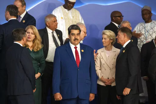 Venezuela's President Nicolas Maduro, center, stands next to the President of the European Commission Ursula von der Leyen, center right, as leaders prepare themselves for a group photo at the COP27 U.N. Climate Summit in Sharm el-Sheikh, Egypt, Nov. 7, 2022. (AP Photo/Nariman El-Mofty, File)