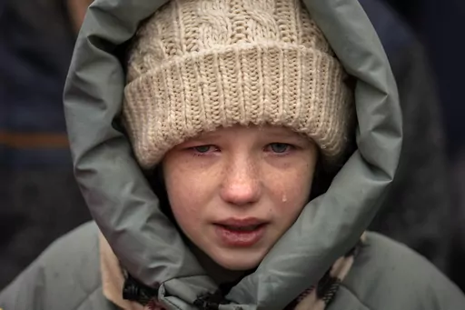 Anna, 10, cries next to the body of her brother Yurii, 27, during his funeral in Kalynivka, near Kyiv, Ukraine, Tuesday, Feb. 21, 2023. Yurii Kulyk, a civilian who was a volunteer in the armed forces of Ukraine, was killed during a rocket attack on Feb.15 in Lyman, a city in the Donetsk region of Ukraine. (AP Photo/Emilio Morenatti)