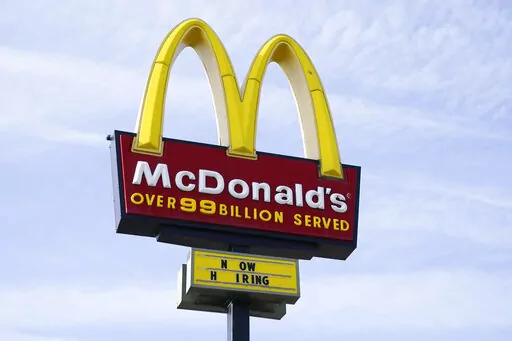 A sign is displayed outside a McDonald's restaurant, Tuesday, April 27, 2021, in Des Moines, Iowa.  McDonald’s said Tuesday, March 8, 2022,  it is temporarily closing all of its 850 restaurants in Russia in response to the country's invasion of Ukraine. The burger giant said it will continue paying its 62,000 employees in Russia.  (AP Photo/Charlie Neibergall, File)