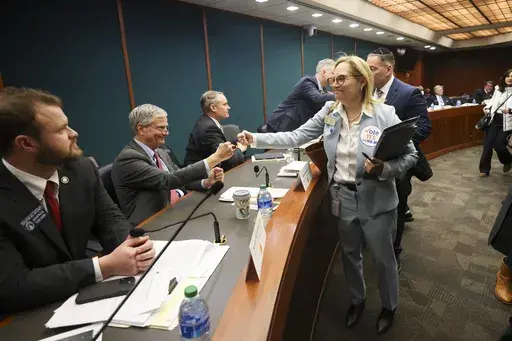 Rep. Esther Panitch, D-Sandy Springs, right, fist bumps Sen. Ben Watson, R-Savannah, a member of the Senate Judiciary Committee, after House Bill 30, an antisemitism bill, was passed unanimously by the Senate Judiciary Committee in the Coverdell Legislative Office Building, Monday, Jan. 22, 2024, in Atlanta. (Jason Getz/Atlanta Journal-Constitution via AP)