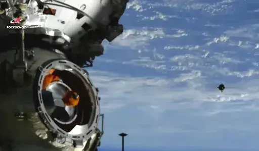 In this image taken from video footage released by the Roscosmos Space Agency, the Soyuz MS-21 space ship, right, approaches the International Space Station, ISS, during docking to the station, Friday, March 18, 2022.  The head of Russia’s space program says the future of the International Space Station hangs in the balance after the United States, the European Union and Canadian space agencies missed a deadline to meet Russian demands for lifting sanctions on Russian enterprises and hardware.