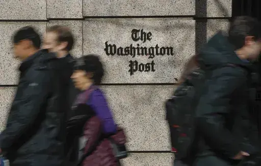 People walk by the One Franklin Square Building, home of The Washington Post newspaper, in downtown Washington, Feb. 21, 2019. The struggling Washington Post was in some turmoil on Monday, June 3, 2024, following a hastily announced restructuring plan aimed at stopping an exodus of readers over the past few years, and the departure of the newspaper's executive editor, Sally Buzbee. (AP Photo/Pablo Martinez Monsivais, File)