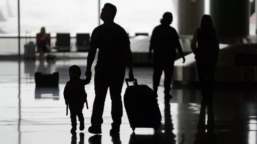 People travel through Salt Lake City International Airport on Wednesday, Feb. 22, 2023, in Salt Lake City. When discussing a multigenerational family trip, have a plan to avoid arguments around topics like when to travel, where you’ll go, what you’ll do there or how you’ll split bills. With groups, it’s often best for each family unit to book their lodging and transportation. (AP Photo/Rick Bowmer, File)