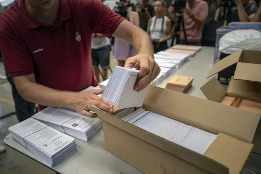 An election worker shows ballots to the media before being distributed at polling stations, at a warehouse in Barcelona, Spain, July 18, 2023. Claims of vote rigging and election fraud are spreading in Spain ahead of that nation's pivotal election on Sunday. The allegations are strikingly similar to claims spread by ex-President Donald Trump and others in the United States ahead of the 2020 election. (AP Photo/Emilio Morenatti, File)