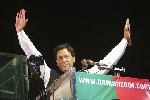 Former Pakistani Prime Minister Imran Khan waves to his supporters during an anti government rally, in Lahore, Pakistan, April 21, 2022. Pakistani police have filed terrorism charges against Khan, authorities said Monday, Aug. 22, 2022, escalating political tensions in the country as he holds mass rallies seeking to return to office. (AP Photo/K.M. Chaudary, File)
