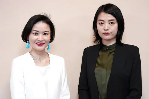 Prosecutors Tomoko Suzuki, left, and Rina Ito pose for a photographer during an interview at Tokyo District Public Prosecutors Office Monday, Feb. 27, 2023, in Tokyo. Twenty years ago, only about 8% of Japanese prosecutors were women. By 2018, that number rose to nearly a third of newly hired prosecutors. This year, the male-female ratio reached 50-50, according to the Tokyo District Prosecutors Office. (AP Photo/Eugene Hoshiko)