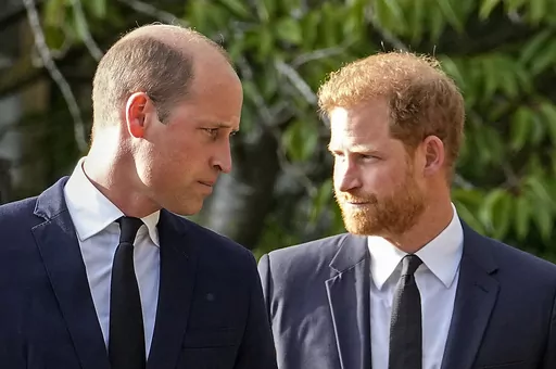 Britain's Prince William and Britain's Prince Harry walk beside each other after viewing the floral tributes for the late Queen Elizabeth II outside Windsor Castle, in Windsor, England, Saturday, Sept. 10, 2022. Court papers say that Prince William quietly received “a very large sum of money” in a 2020 phone hacking settlement with the British newspaper arm of Rupert Murdoch’s media empire. Court documents aired Tuesday in one of his brother's lawsuits against British newspapers says the P