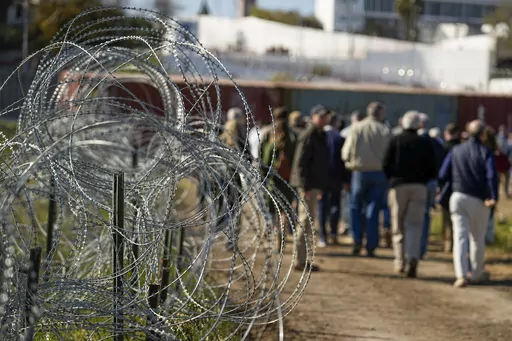 Concertina wire lines the path as members of Congress tour an area near the Texas-Mexico border, Jan. 3, 2024, in Eagle Pass, Texas. As congressional negotiators try to finalize a bipartisan deal on the border and immigration, their effort is drawing the wrath of hard-right lawmakers and former President Donald Trump. That vocal opposition threatens to unravel a delicate compromise. (AP Photo/Eric Gay, File)