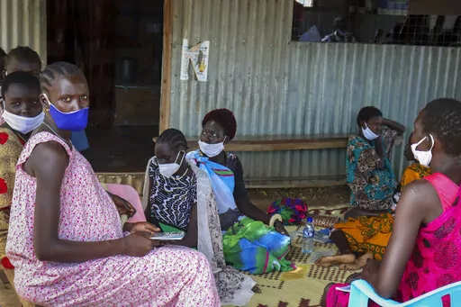 Expectant mothers sit on the floor as they wait to attend a monthly checkup at the Mingkaman Reproductive Health Clinic in the village of Mingkaman, Awerial County, in the Lakes State of South Sudan Wednesday, Oct. 19, 2022. In a country with one of the world's highest maternal mortality rates, the small clinic dedicated to reproductive health care for more than 200,000 people is about to be shut down - just one casualty among many in developing countries as humanitarian donors are stretched by 