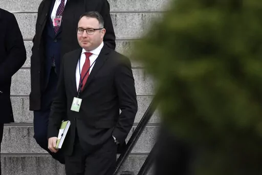 In this Jan. 27, 2020, file photo Army Lt. Col. Alexander Vindman, a military officer at the National Security Council who testified during the impeachment hearings on Capitol Hill, walks down the steps of the Eisenhower Executive Office Building on the White House complex in Washington. Vindman who was a pivotal witness in the first impeachment case against Donald Trump has sued the oldest son of the former president and other Trump allies, accusing them of participating in an “intentional, c