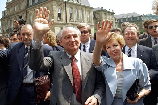 Soviet President Mikhail S. Gorbachev (l) and his wife Raisa wave to well wishers when strolling through market place in downtown Stuttgart, Wednesday, June 14, 1989. In background is the New Castle where Gorbachev had talks with representatives of West German state Baden-Wurttemberg. When Mikhail Gorbachev is buried Saturday at Moscow's Novodevichy Cemetery, he will once again be next to his wife, Raisa, with whom he shared the world stage in a visibly close and loving marriage that was unprece