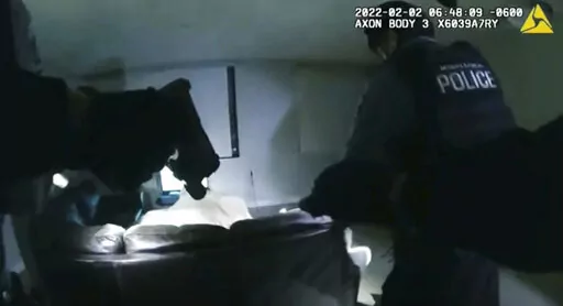 In this image taken from Minneapolis Police Department body camera video and released by the city of Minneapolis, Minneapolis police enter an apartment on Wednesday, Feb. 2, 2022, moments before shooting 22-year-old Amir Locke. Minneapolis Mayor Jacob Frey has imposed a moratorium on no-knock warrants after Locke was killed as a SWAT team carried out a search warrant in a downtown apartment. (Minneapolis Police Department via AP)