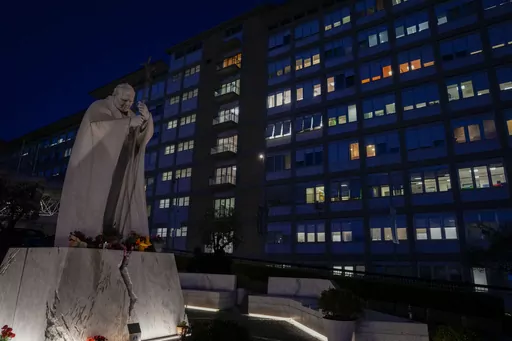 A statue of late Pope St. John Paul II is backdropped by the Agostino Gemelli hospital in Rome, Wednesday, March 29, 2023, after The Vatican said Pope Francis has been taken there in the afternoon for some scheduled tests. The Vatican provided no details, including how long the 86-year-old pope would remain at Gemelli University Hospital, where he underwent surgery in 2021. But his audiences through Friday were canceled, raising questions about Francis' participation during the Vatican's Holy We