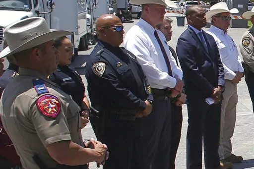 Uvalde School Police Chief Pete Arredondo, third from left, stands during a news conference outside of the Robb Elementary school in Uvalde, Texas Thursday, May 26, 2022. (AP Photo/Dario Lopez-Mills)