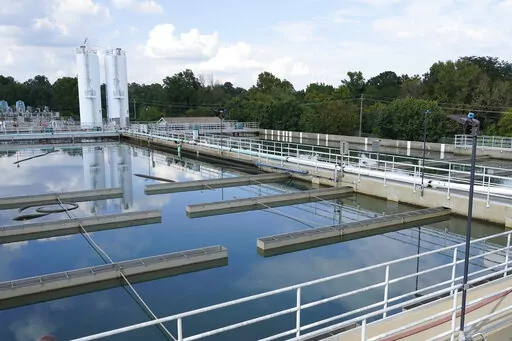 FILE -Clouds are reflected off the City of Jackson's O.B. Curtis Water Treatment Facility's sedimentation basins in Ridgeland, Miss., Friday, Sept. 2, 2022. Mississippi's capital city has been awarded a tranche of federal funds to help fix its crumbling water infrastructure. The infusion of funds arrives after flooding-induced breakdowns at Jackson's main water treatment plant in late August left 150,000 people without running water for several days. (AP Photo/Rogelio V. Solis, File)