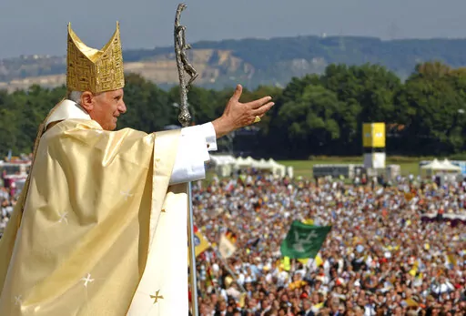 Pope Benedict XVI waves to the crowd at the end of a papal Mass at the Islinger field in Regensburg, southern Germany, some 120 kilometers (about 75 miles) northeast of Munich, on Tuesday, Sept. 12, 2006. Pope Benedict XVI leaves his homeland with a complicated legacy: pride in a German pontiff but a church deeply divided over the need for reforms in the wake of a sexual abuse scandal in which his own actions of decades ago were faulted. (AP Photo/Wolfgang Radke, Pool, File)