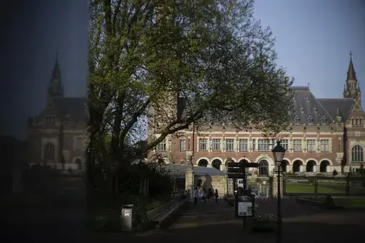 The Peace Palace housing the World Court, or International Court of Justice, is reflected in a monument in The Hague, Netherlands, Wednesday, May 1, 2024. (AP Photo/Peter Dejong, File)