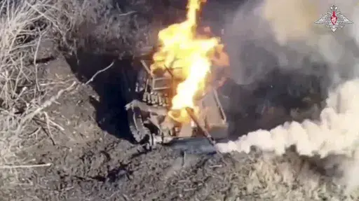 According to this photo taken from video distributed by the Russian Defense Ministry Press Service on Monday, Jan. 13, 2025, a Ukrainian tank burns after being hit by a Russian drone near the settlement of Vozdvizhenka, eastern Ukraine. (Russian Defense Ministry Press Service via AP)
