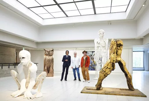 In this photo provided by Sara Hilden Art Museum, British artist Thomas Houseago, centre, poses with US actor Brad Pitt, centre right and Australian musician Nick Cave, prior to the opening of their joint exhibition, in Tampere, Finland, Saturday, Sept. 17, 2022. (Jussi Koivunen/Sara Hilden Art Museum, Lehtikuva via AP)
