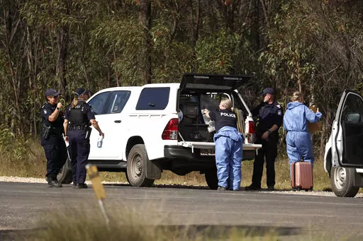 Police work near the scene of a fatal shooting in Wieambilla, Australia, Tuesday, Dec. 13, 2022. Multiple people, including a few police officers, were shot and killed at a property in rural Australia after officers who arrived to investigate reports of a missing person were ambushed, authorities said. (Jason O'Brien/AAP Image via AP)