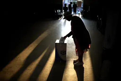A woman casts her ballot at a polling station, during general elections in Eshowe, South Africa, on May 29, 2024. South Africa is in a moment of deep soul-searching after an election that brought a jarring split from the African National Congress, the very party that gave the country freedom and democracy 30 years ago. (AP Photo/Emilio Morenatti, File)