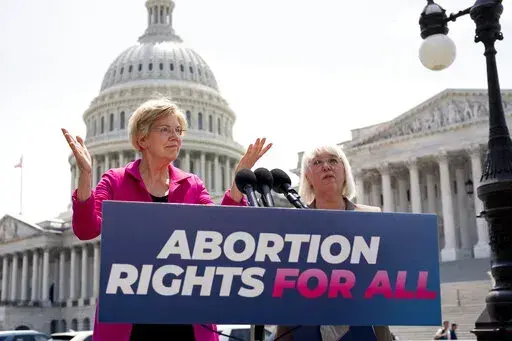 Sen. Elizabeth Warren, D-Mass., and Sen. Patty Murray, D-Wash., talk to reporters as the Supreme Court is poised to possibly overturn Roe v. Wade, at the Capitol in Washington, June 15, 2022.  The Democratic National Committee is launching a digital ad campaign to energize its voters after last month’s Supreme Court decision overturning Roe v. Wade. The ad campaign warns that Republicans’ ultimate goal is to outlaw abortion nationwide.  (AP Photo/J. Scott Applewhite, File)