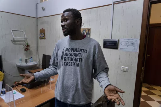 Mamadou Kouassi, left, a migrant who made the journey from his native Ivory Coast to Italy in 2006, talks to The Associated Press during an interview in a migrant center in Castel Volturno, southern Italy, where he now dedicates his life to working with migrants, Thursday, Feb. 1, 2024. Kouassi's odyssey through Africa inspired the movie Io Capitano (Me Captain) to Italian director Matteo Garrone and is among the nominees for the 2024 96th Academy Awards in the International Feature Film categor