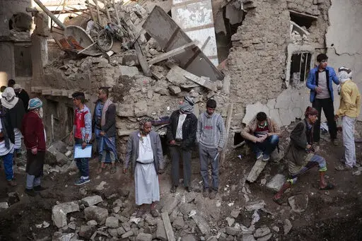 People gather at the site of a Saudi-led airstrike near Yemen's Defense Ministry complex in Sanaa, Yemen, Saturday, Nov. 11, 2017. The world must not lose sight of the plight of those living through the yearslong war in Yemen, Katharina Ritz, the International Committee of the Red Cross’ head of delegation in Yemen said Friday, March 11, 2022, urging continued aid for the Middle East's poorest nation as the war in Ukraine grabs the world's attention. (AP Photo/Hani Mohammed)