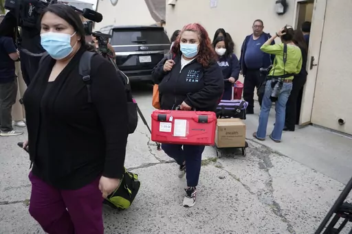 Los Angeles County Public Health Emergency Operations officials leave St. Anthony's Croatian Catholic Church after evaluating the newly arrived migrants being housed in Los Angeles on Wednesday, June 14, 2023. Forty-two people, including some children, were dropped off at Union Station around 4 p.m. Wednesday and were being cared for at the church. Texas Gov. Greg Abbott said the migrants were sent to Los Angeles because California had declared itself a "sanctuary" for immigrants. (AP Photo/Dami