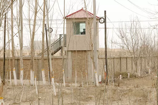 A security guard watches from a tower around a detention facility in Yarkent County in northwestern China's Xinjiang Uyghur Autonomous Region on March 21, 2021. As world leaders gather in New York at the annual U.N. General Assembly, rising superpower China is also focusing on another United Nations body that is meeting across the Atlantic Ocean in Geneva.  (AP Photo/Ng Han Guan, File)