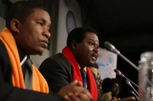 Coordinator Mithika Mwenda, left, and committee member Augustine Njamnshi, right,at a press conference of the Pan African Climate Justice Alliance at the Climate Summit, in Copenhagen Denmark, on Dec. 10, 2009. Climate activists in Africa have expressed anger toward the United Nations climate agency, accusing it of allowing corporations and individuals with “dubious” climate credentials to “greenwash” their polluting activities by participating in its annual climate conference. The criti