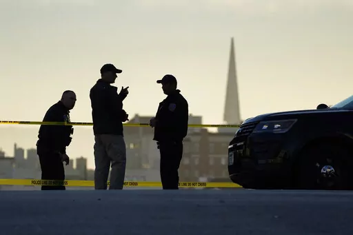 Police stand at the top of the closed street outside the home of House Speaker Nancy Pelosi and her husband Paul Pelosi in San Francisco, Friday, Oct. 28, 2022. Within hours of the attack on Paul Pelosi, conspiracy theories deflecting blame for the assault on the husband of U.S. Speaker Nancy Pelosi were already swirling online. (AP Photo/Eric Risberg, File)